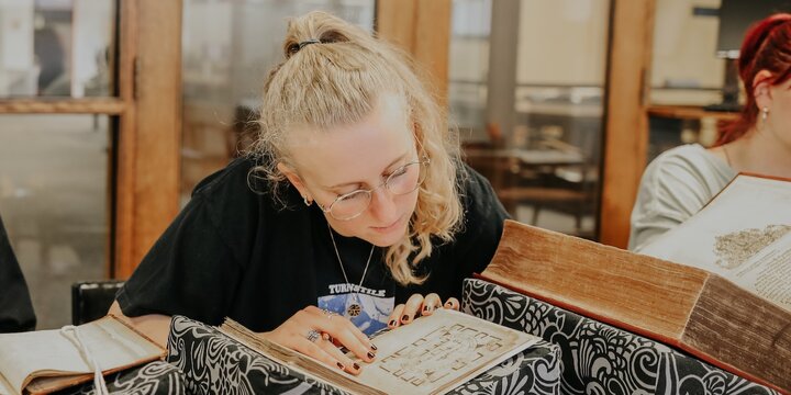 Student reads a book in the Rare Book Library