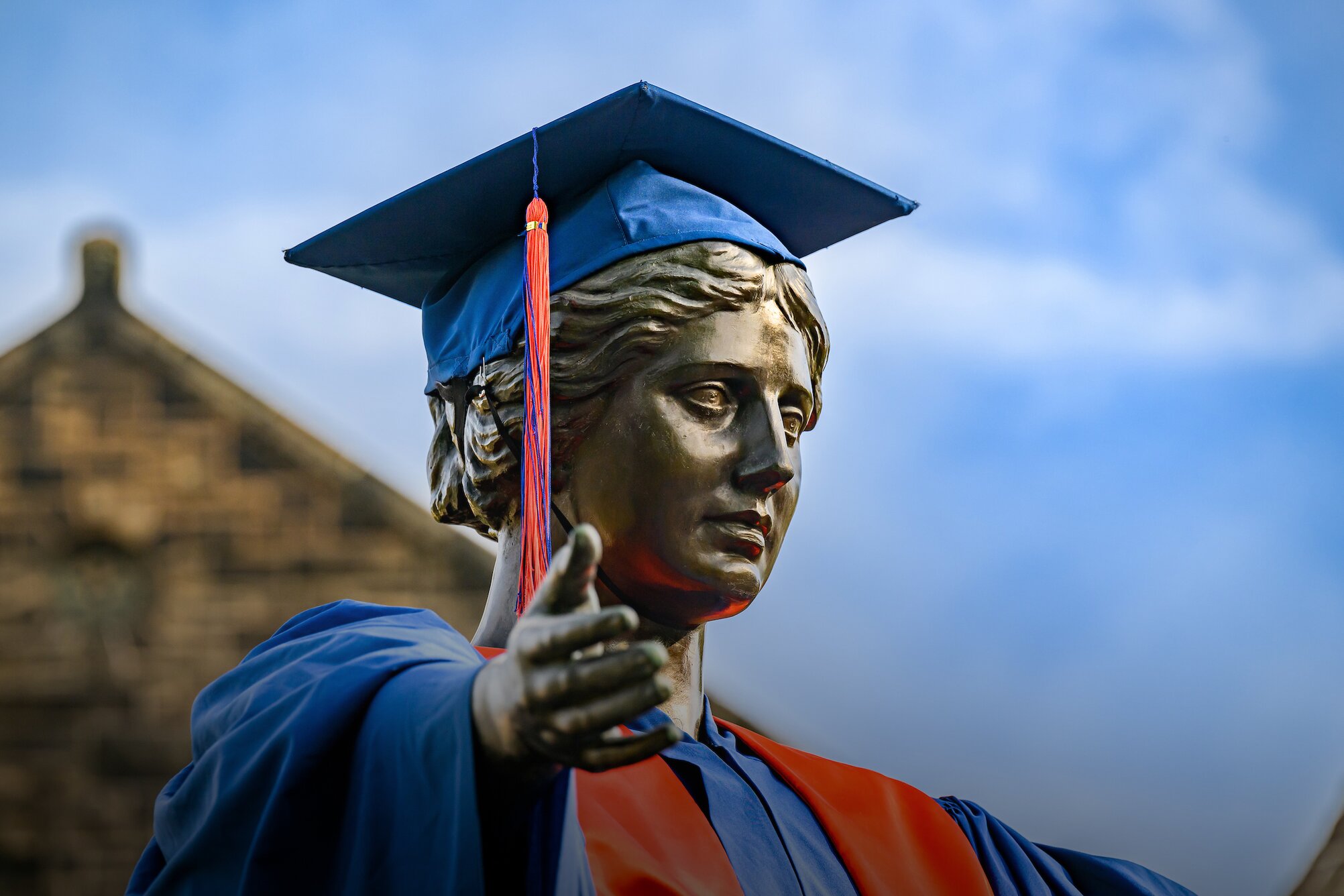 alma mater wearing cap and gown