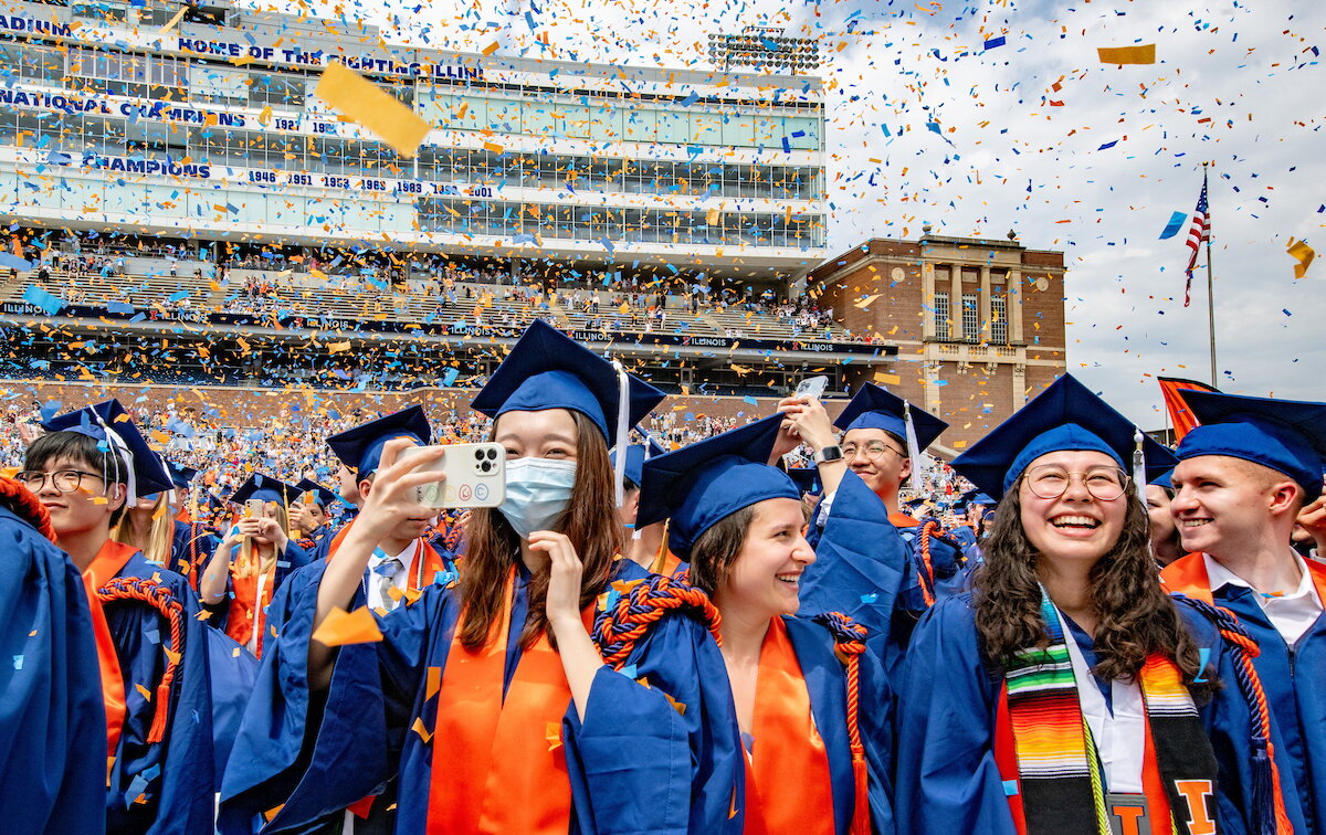 Recent graduates celebrating in cap and gown