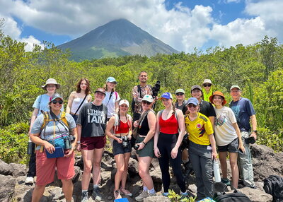 Kanter with students in front of a mountain in Costa Rica